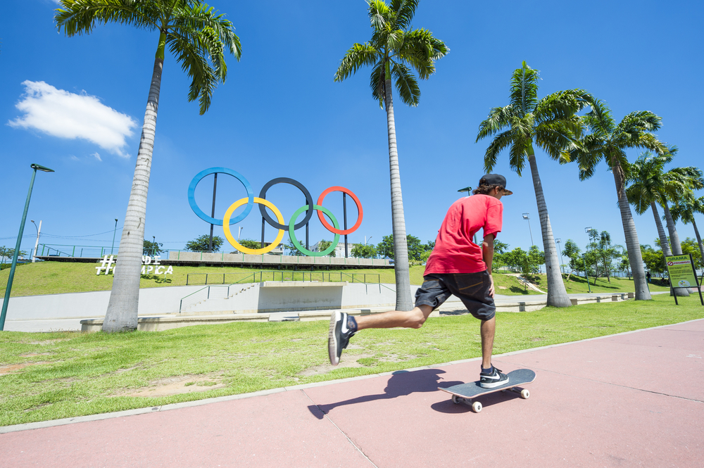 skateboarder in front of Olympic logo